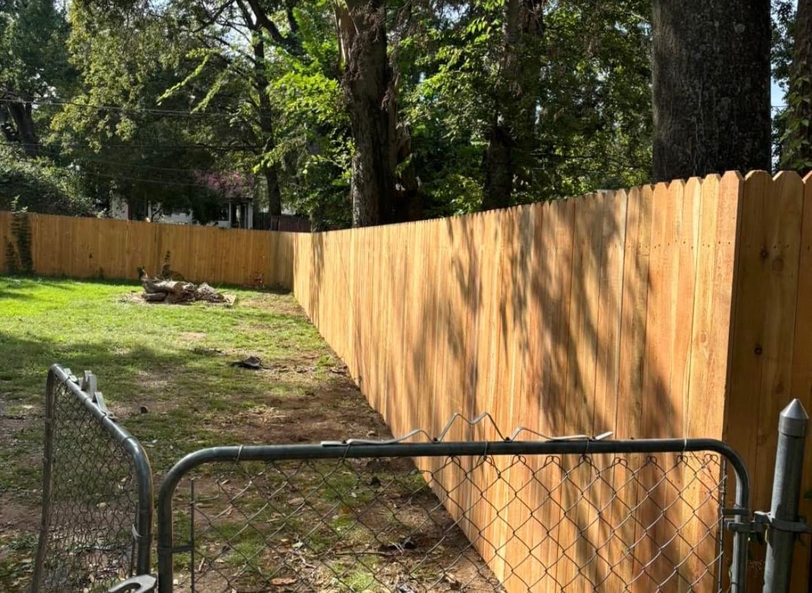 New backyard wood fence installation in Tulsa, Oklahoma, after replacing worn picket fencing